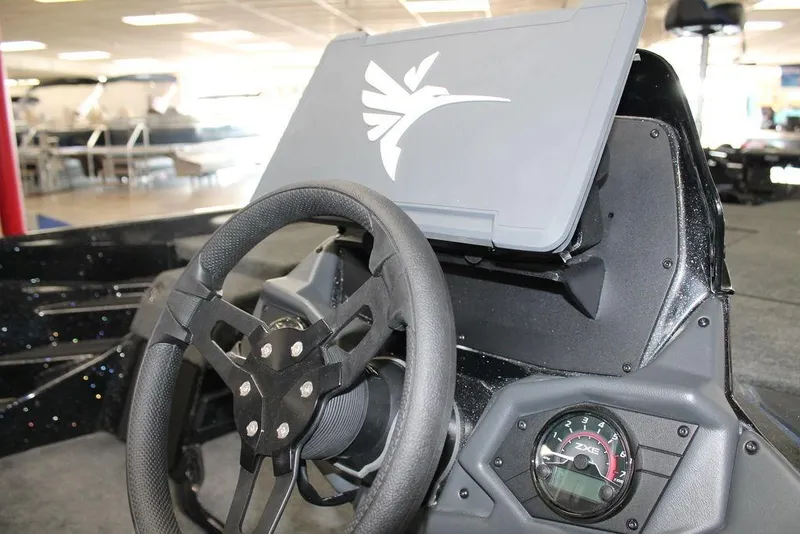 Slide: The Image of 2026 Skeeter ZXE20 boat dashboard with steering wheel and gauge display. - 8