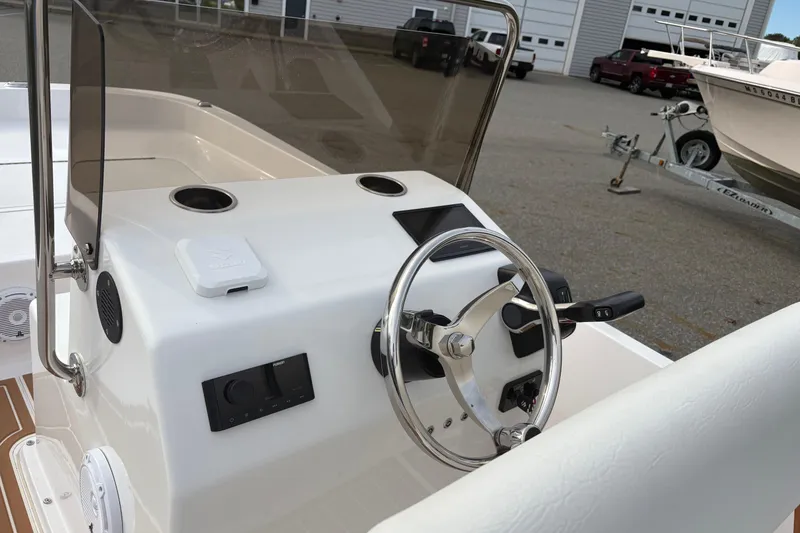 Slide: The Image of 2024 Wolfeboro 15 Classic boat dashboard with steering wheel and controls. - 12