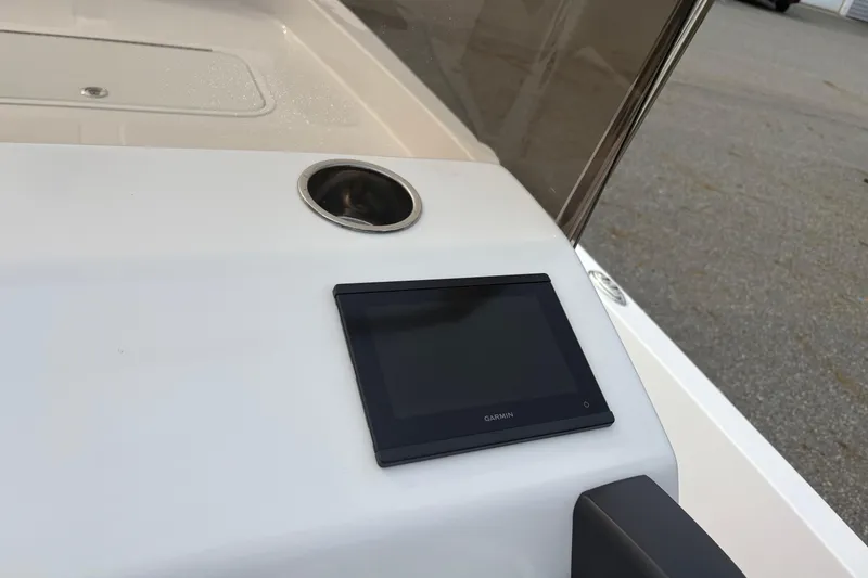 Slide: The Image of 2024 Wolfeboro 15 Classic boat dashboard with Garmin display and cup holder. - 13
