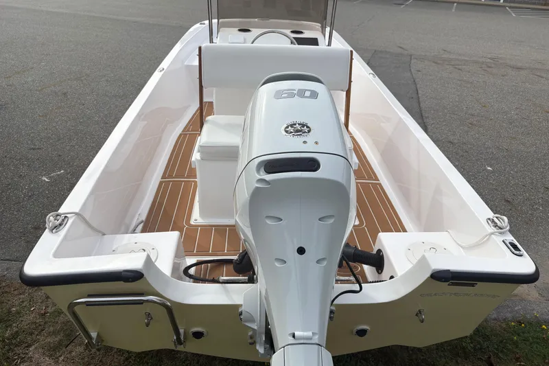 Slide: The Image of 2024 Wolfeboro 15 Classic boat with 60 HP outboard motor, teak deck, and white seating. - 5