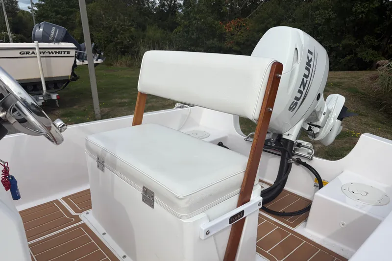 Slide: The Image of 2024 Wolfeboro 15 Classic boat interior with Suzuki outboard motor. - 7