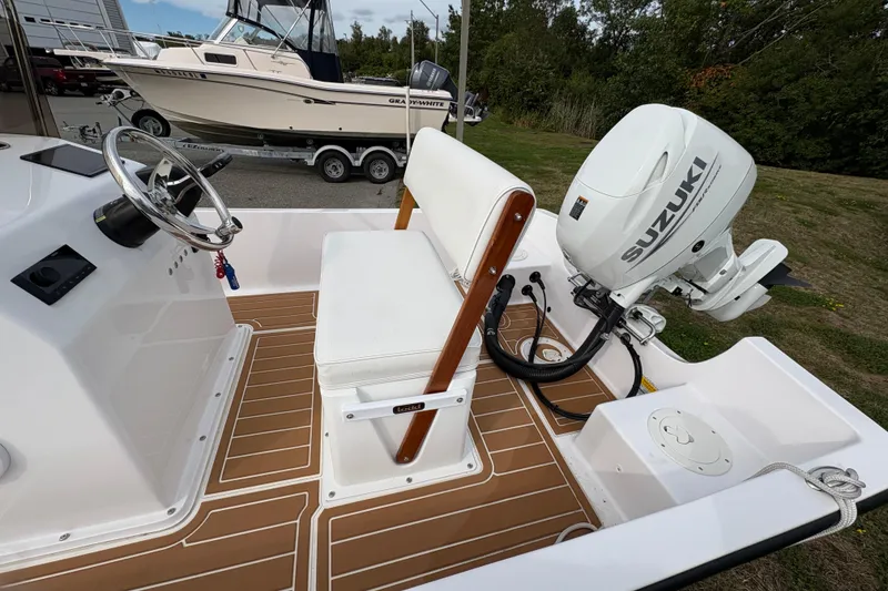 Slide: The Image of 2024 Wolfeboro 15 Classic boat interior with Suzuki outboard motor, featuring sleek design and modern controls. - 8