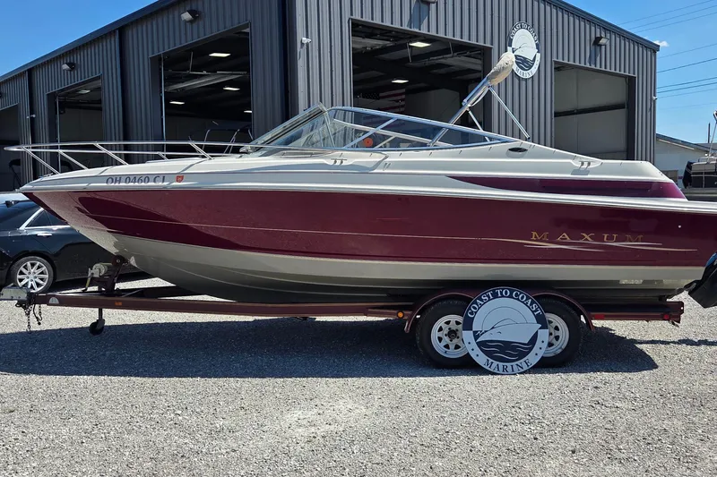 Slide: The Image of 1998 Maxum 2300 SC boat on trailer outside Coast to Coast Marine facility. - 1