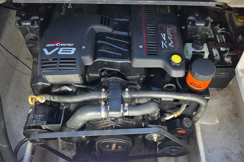 Slide: The Image of MerCruiser V8 engine in a 1998 Maxum 2300 SC boat, showcasing components and layout. - 12