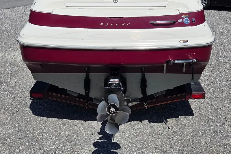 Slide: The Image of Rear view of a 1998 Maxum 2300 SC boat with visible propeller and trailer. - 2
