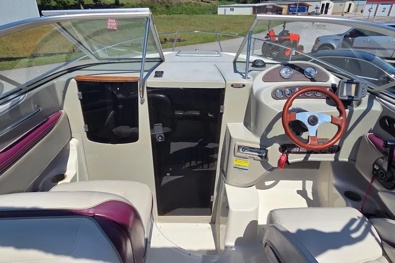 Slide: The Image of 1998 Maxum 2300 SC boat interior with steering wheel and dashboard controls. - 4