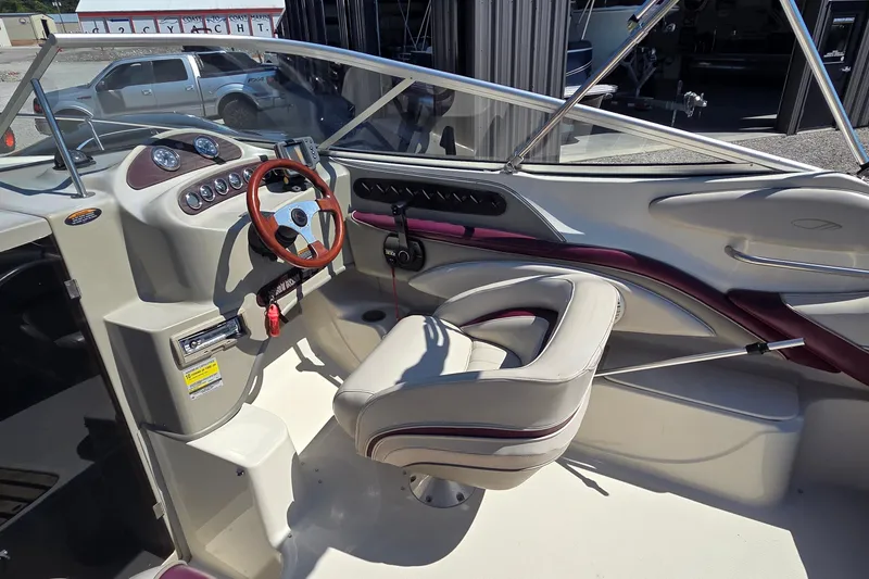 Slide: The Image of 1998 Maxum 2300 SC boat interior with steering wheel and dashboard controls. - 5