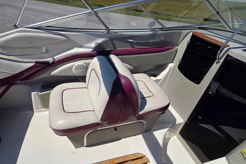 Slide: The Image of 1998 Maxum 2300 SC boat interior with white and burgundy seating. - 6