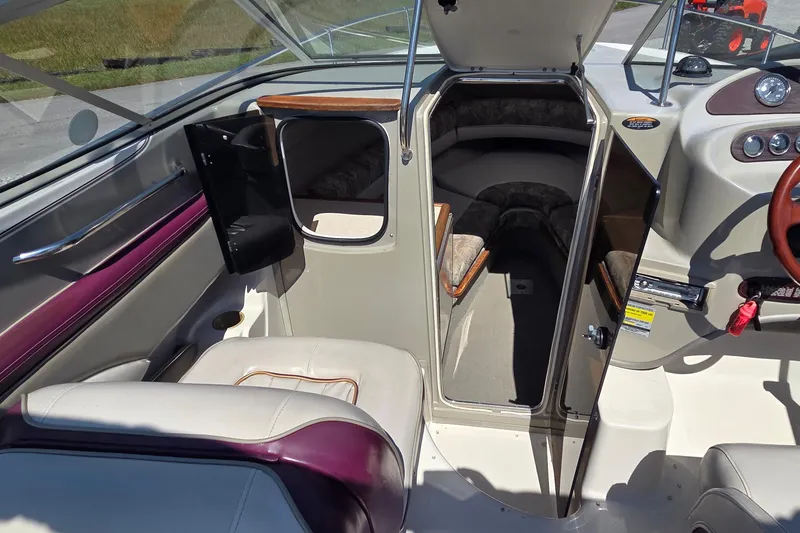 Slide: The Image of Interior view of a 1998 Maxum 2300 SC boat cabin with seating and dashboard. - 7