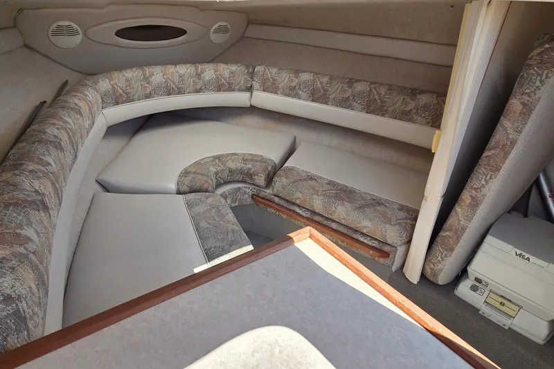 Slide: The Image of 1998 Maxum 2300 SC cabin interior with cushioned seating and storage space. - 9