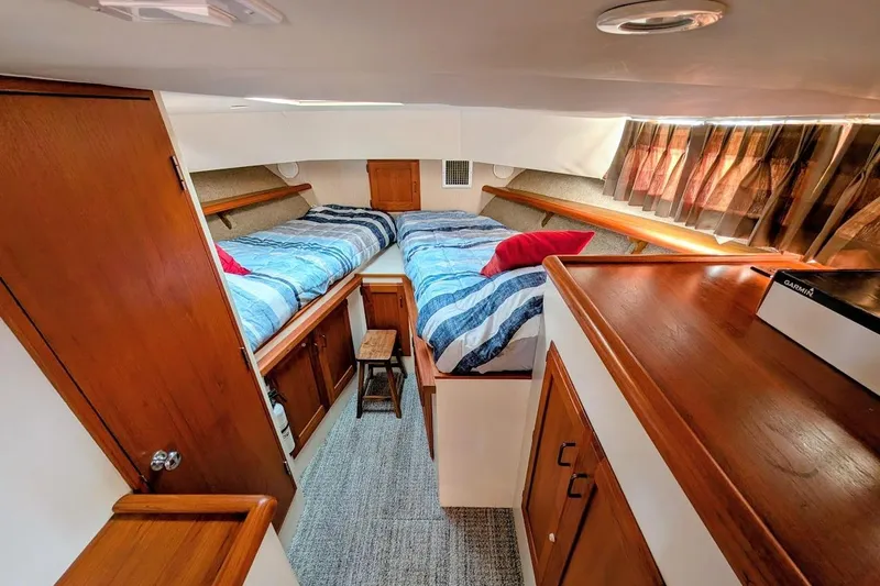 Slide: The Image of 1978 Tollycraft 54 Custom Cockpit Motor Yacht cabin with twin beds and wooden interior. - 31
