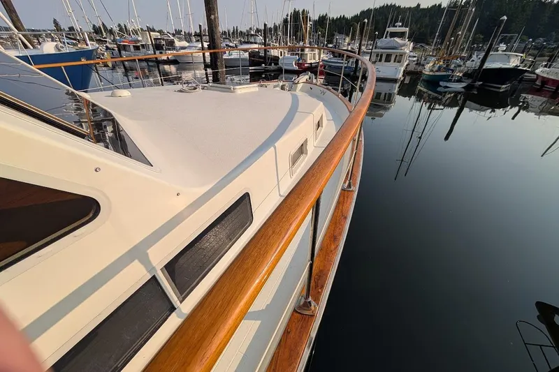 Slide: The Image of 1978 Tollycraft 54 Custom Cockpit Motor Yacht docked in a serene marina. - 4