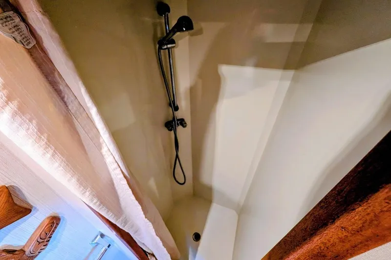 Slide: The Image of Shower area in 1978 Tollycraft 54 Custom Cockpit Motor Yacht, featuring a handheld showerhead. - 41