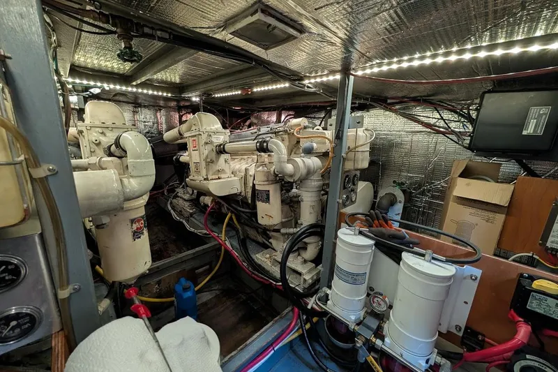 Slide: The Image of Engine room of a 1978 Tollycraft 54 Custom Cockpit Motor Yacht, featuring dual engines. - 52
