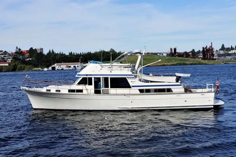 The Image of 1978 Tollycraft 54 Custom Cockpit Motor Yacht cruising on a scenic waterway. - 0
