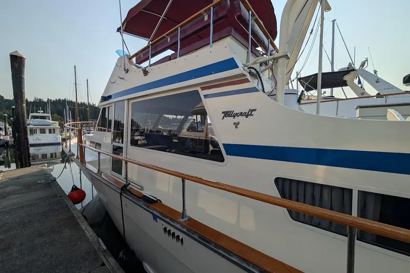 Slide: The Image of 1978 Tollycraft 54 Custom Cockpit Motor Yacht docked at marina, side view. - 1