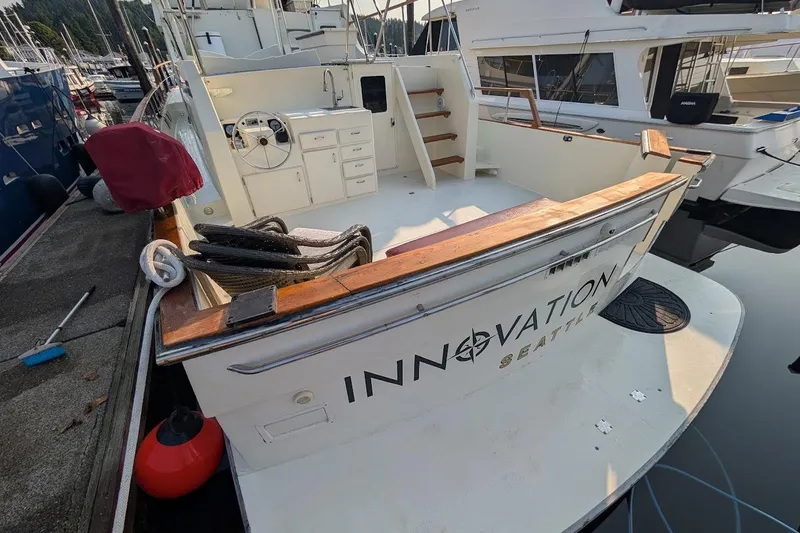 Slide: The Image of 1978 Tollycraft 54 Custom Cockpit Motor Yacht docked, featuring spacious deck and elegant design. - 11