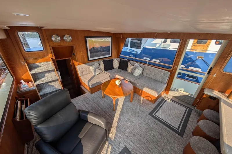 Slide: The Image of Interior of 1978 Tollycraft 54 Custom Cockpit Motor Yacht with cozy seating and elegant decor. - 13