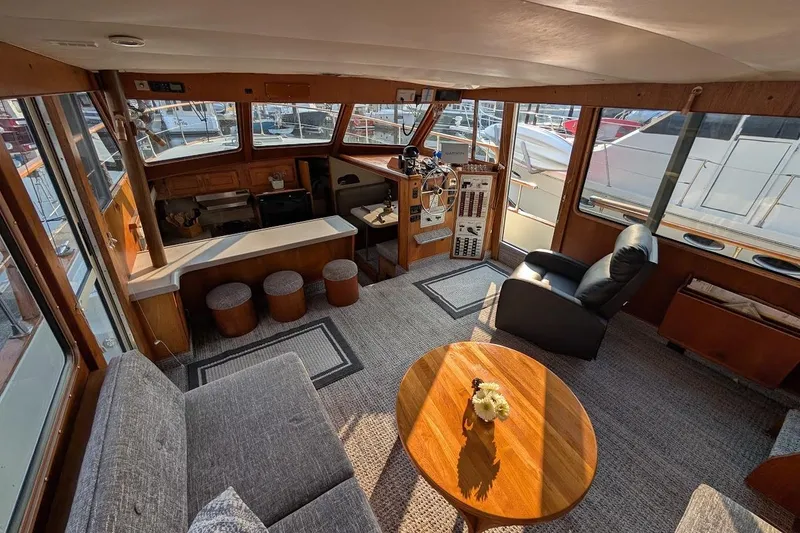 Slide: The Image of 1978 Tollycraft 54 Custom Cockpit Motor Yacht interior with helm, seating, and wooden accents. - 16