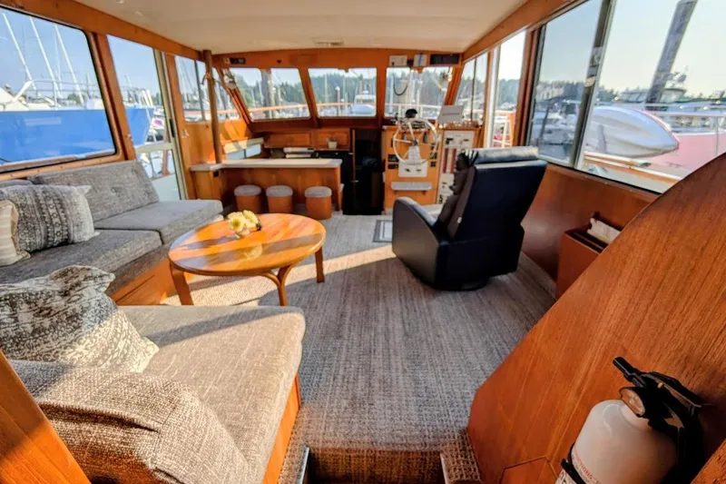 Slide: The Image of 1978 Tollycraft 54 Custom Cockpit Motor Yacht interior with cozy seating and helm. - 17