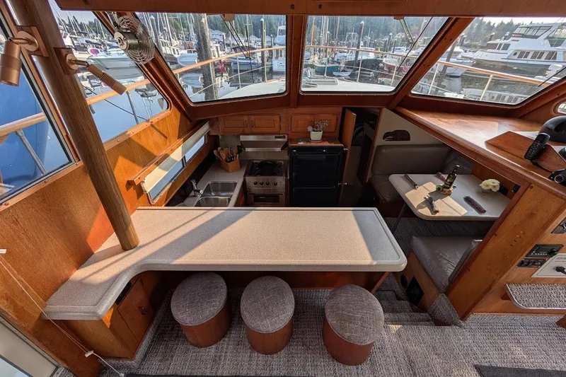 Slide: The Image of 1978 Tollycraft 54 Custom Cockpit Motor Yacht interior with kitchen and seating area. - 18