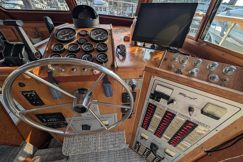 Slide: The Image of 1978 Tollycraft 54 Custom Cockpit Motor Yacht helm with gauges, steering wheel, and control panel. - 19