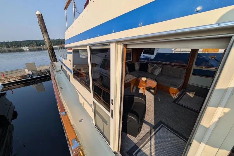 Slide: The Image of 1978 Tollycraft 54 Custom Cockpit Motor Yacht with open cabin and waterfront view. - 2