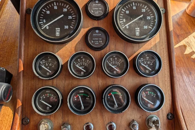 Slide: The Image of Dashboard of a 1978 Tollycraft 54 Custom Cockpit Motor Yacht with various gauges and controls. - 20
