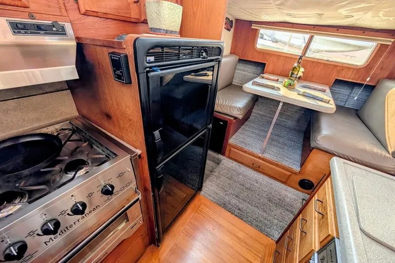 Slide: The Image of 1978 Tollycraft 54 Custom Cockpit Motor Yacht interior with kitchen and dining area. - 26