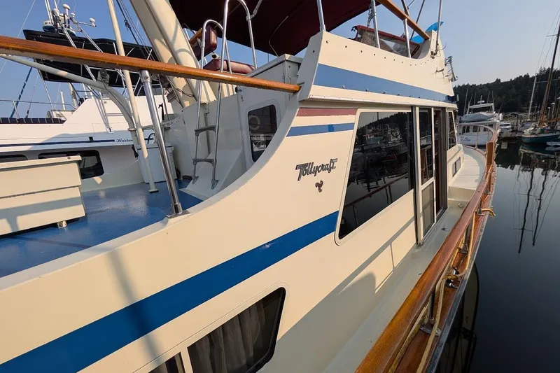 Slide: The Image of 1978 Tollycraft 54 Custom Cockpit Motor Yacht docked in a marina, showcasing sleek design. - 3
