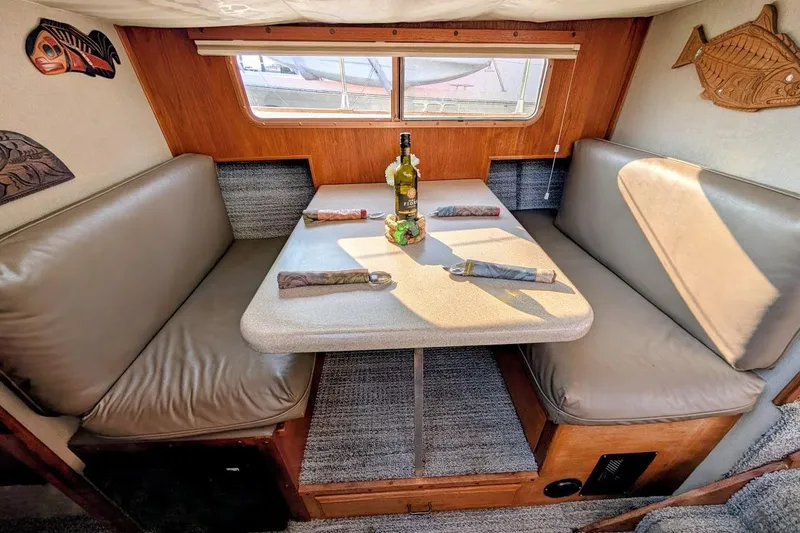 Slide: The Image of Cozy dining area in 1978 Tollycraft 54 Custom Cockpit Motor Yacht with table and seating. - 30