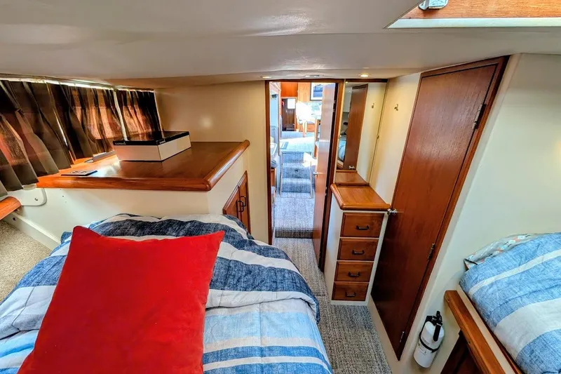 Slide: The Image of 1978 Tollycraft 54 Custom Cockpit Motor Yacht interior with cozy bedroom and wooden cabinetry. - 34