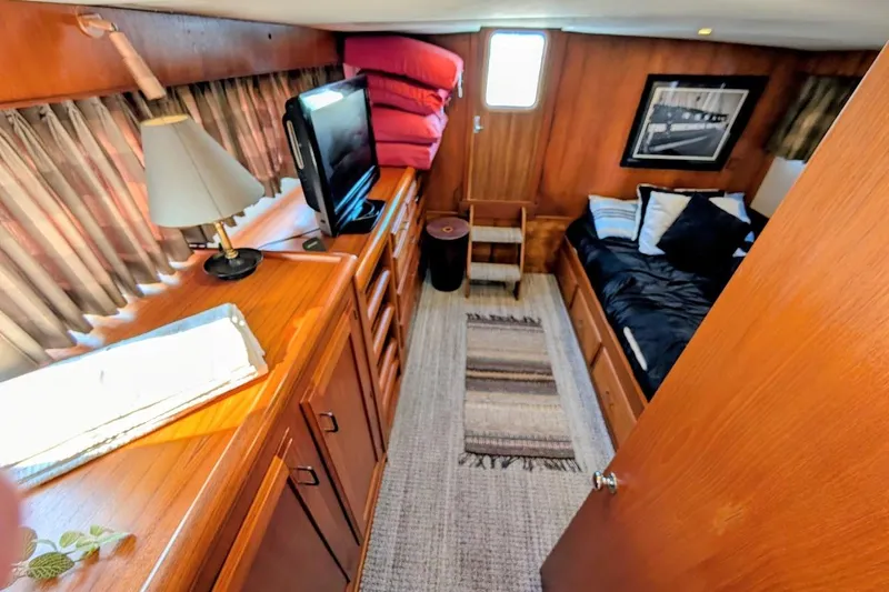 Slide: The Image of Cozy cabin interior of 1978 Tollycraft 54 Custom Cockpit Motor Yacht with wood furnishings. - 36