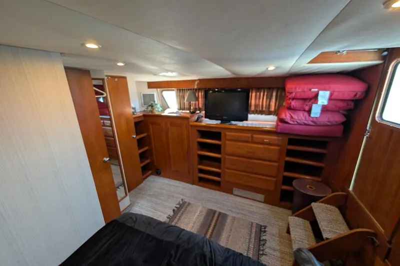 Slide: The Image of 1978 Tollycraft 54 Custom Cockpit Motor Yacht interior with wood cabinetry and cozy furnishings. - 38