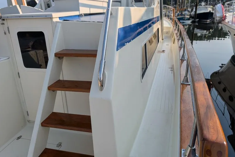 Slide: The Image of 1978 Tollycraft 54 Custom Cockpit Motor Yacht, wooden steps, docked in marina. - 43