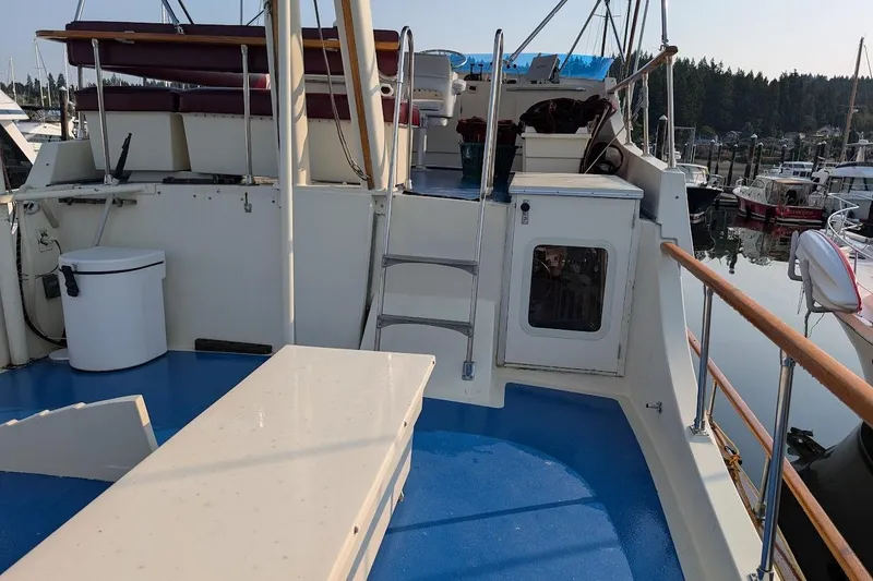 Slide: The Image of 1978 Tollycraft 54 Custom Cockpit Motor Yacht with blue deck and marina view. - 44