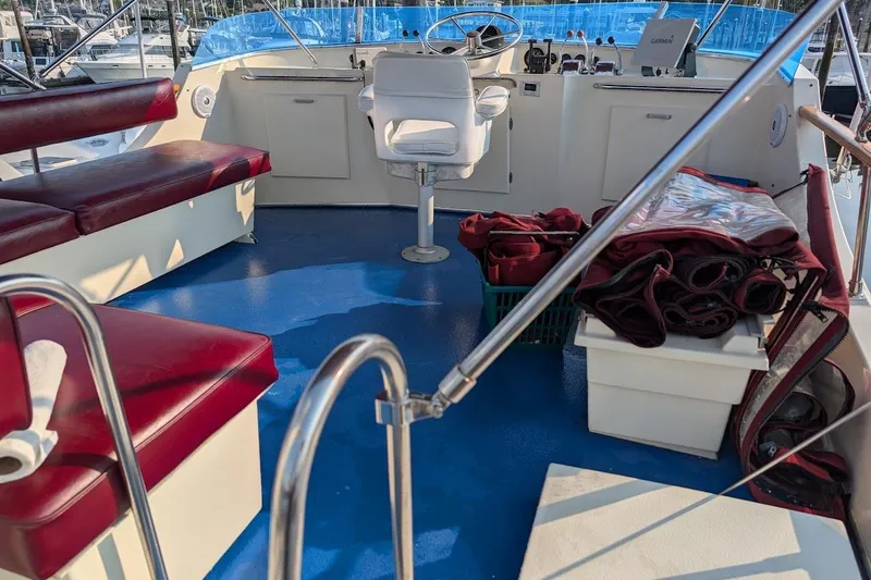 Slide: The Image of 1978 Tollycraft 54 Custom Cockpit Motor Yacht interior with red seating and navigation equipment. - 46