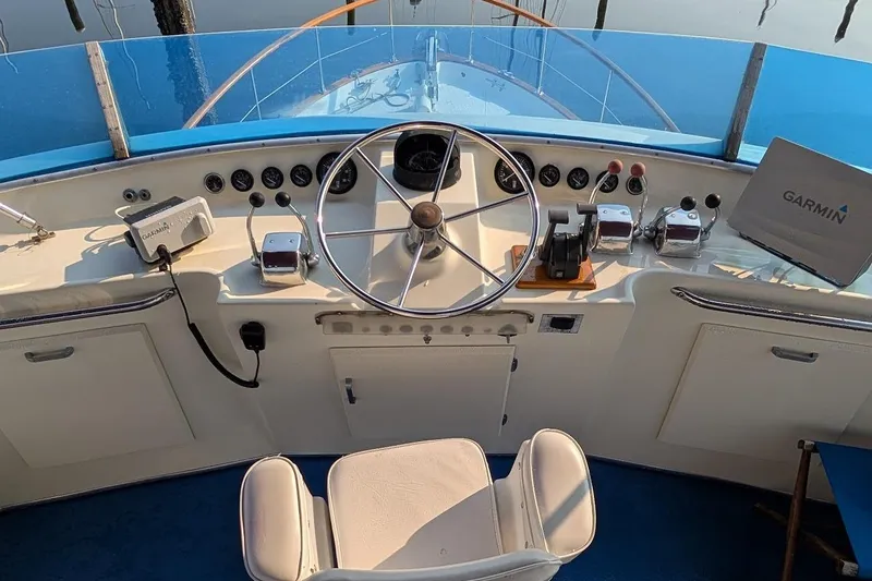 Slide: The Image of 1978 Tollycraft 54 Custom Cockpit Motor Yacht helm with steering wheel and Garmin navigation system. - 47