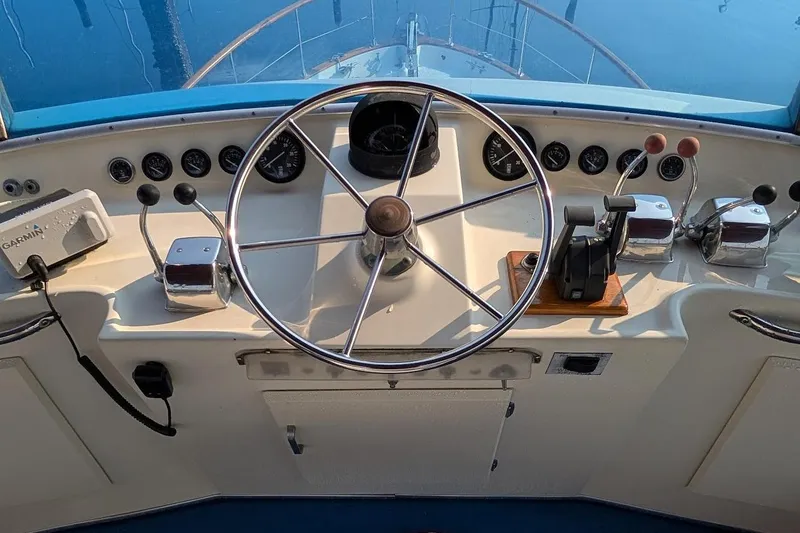 Slide: The Image of 1978 Tollycraft 54 Custom Cockpit Motor Yacht helm with steering wheel and controls. - 48