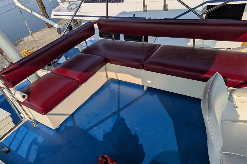 Slide: The Image of 1978 Tollycraft 54 Custom Cockpit Motor Yacht with red seating on blue deck. - 49