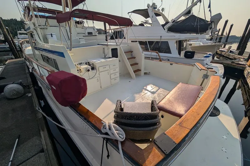 Slide: The Image of 1978 Tollycraft 54 Custom Cockpit Motor Yacht docked, featuring spacious deck and seating area. - 50
