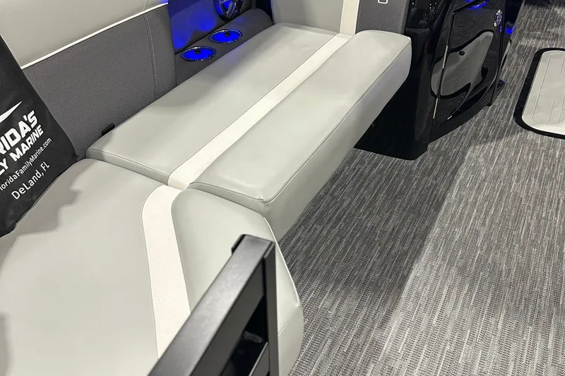 Slide: The Image of 2026 Viaggio Lago X22U boat interior with gray seating and blue cup holders. - 13