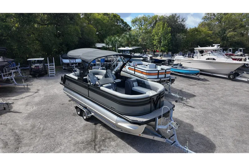 Slide: The Image of 2026 Viaggio Lago X22U pontoon boat on trailer, parked in marina lot. - 3