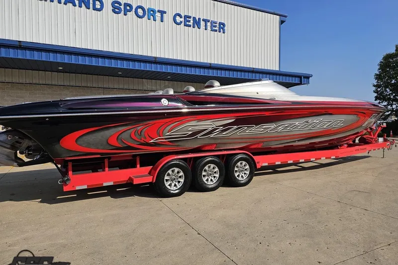 Slide: The Image of 2011 Sunsation F-4 speedboat on red trailer at sport center. - 11