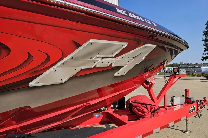 Slide: The Image of Red 2011 Sunsation F-4 boat on trailer, featuring bold graphics and sleek design. - 14