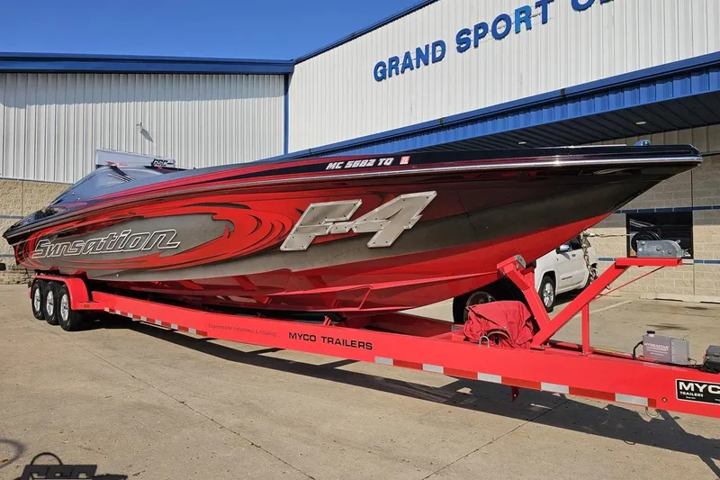 Slide: The Image of 2011 Sunsation F-4 speedboat on red Myco trailer outside Grand Sport Center. - 15