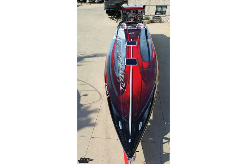Slide: The Image of 2011 Sunsation F-4 speedboat with sleek red and black design, viewed from above. - 17