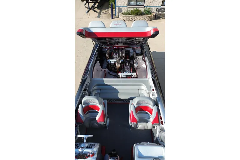 Slide: The Image of 2011 Sunsation F-4 boat interior with open engine compartment, red and gray seating. - 18