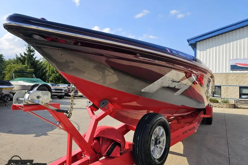 Slide: The Image of 2011 Sunsation F-4 speedboat on trailer, vibrant red and black design, parked outdoors. - 19