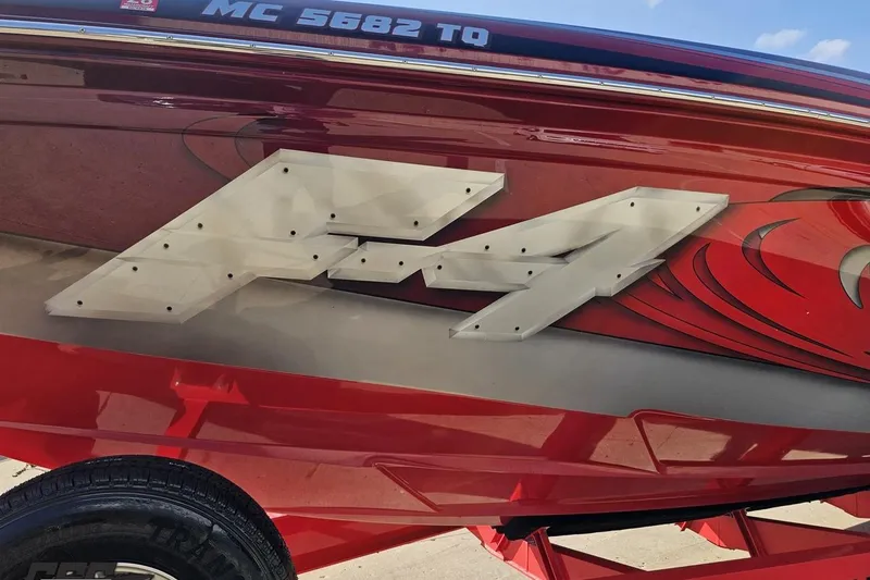 Slide: The Image of 2011 Sunsation F-4 boat with bold graphics and registration number MC 5682 TO. - 20